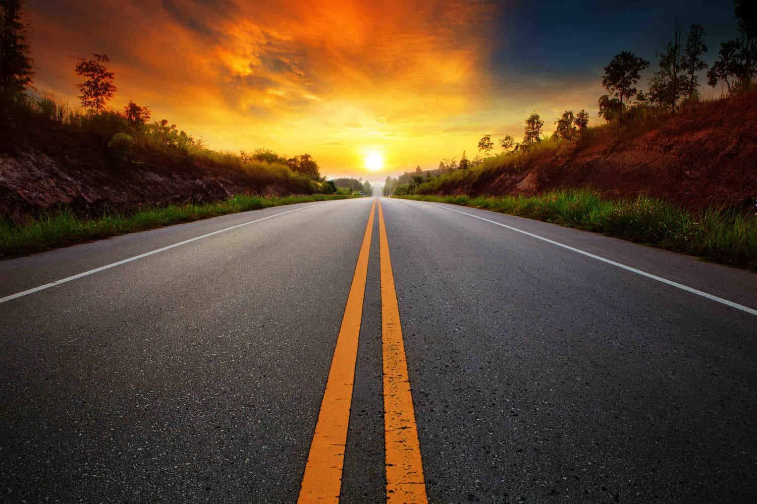 Empty Road at Sunset, With Orange Center Lines — A & S Cuthel Earthmoving & Transport in Dorrigo, NSW
