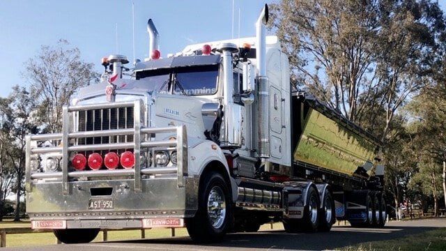 White Truck With Red Lights Parked — A & S Cuthel Earthmoving & Transport in Dorrigo, NSW