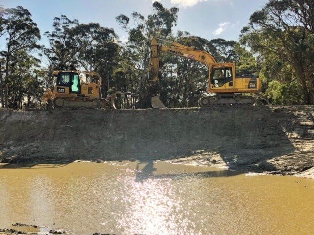 Two Excavators on a Dirt Embankment — A & S Cuthel Earthmoving & Transport in Coffs Harbour, NSW