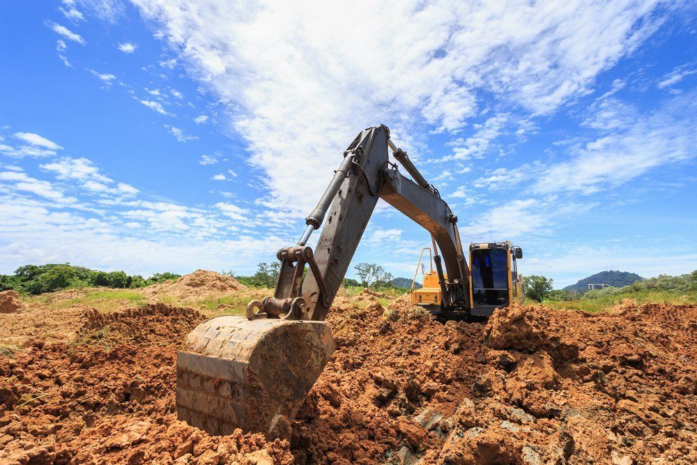 Excavator Digging in a Muddy Construction Site — A & S Cuthel Earthmoving & Transport in Armidale, NSW