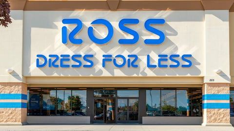 The exterior of a Ross Dress for Less store featuring blue signage on a cream-colored building facade.