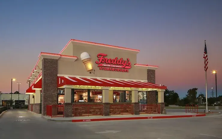 A freddy 's ice cream shop with a red awning