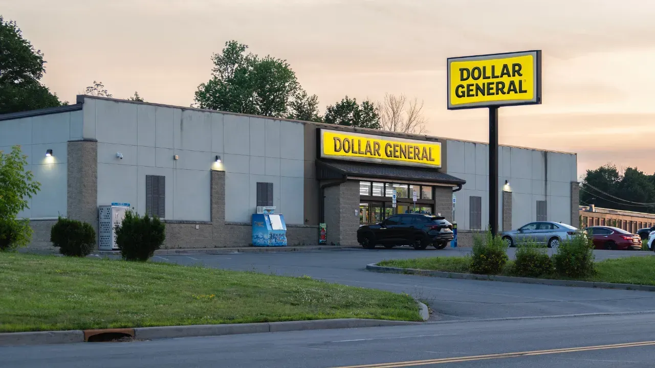 The front of an aldi store with a sign in front of it.