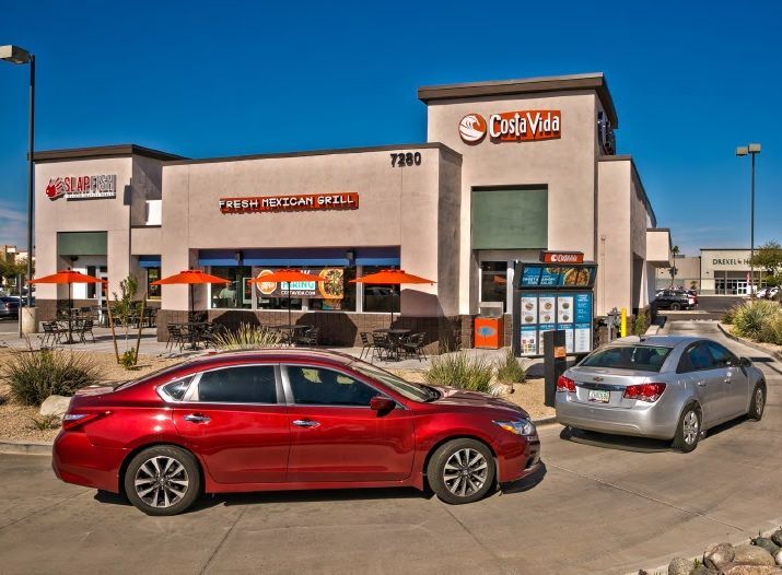 Cars are parked in front of a store called chick-fil-a