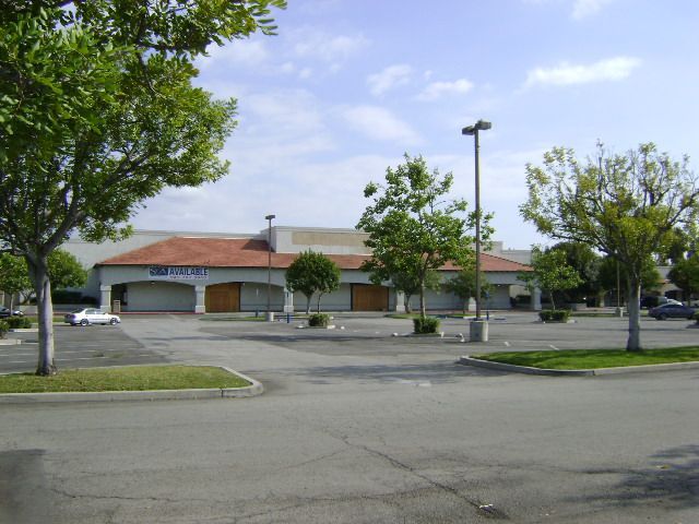 Cars are parked in front of a store called chick-fil-a