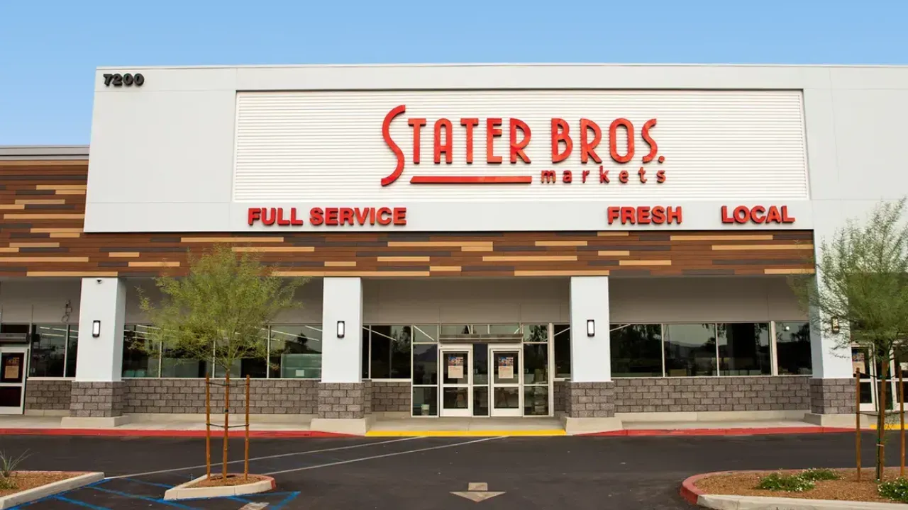 A modern Stater Bros. Markets grocery store exterior with a light-colored facade, wood-paneled accents, and a paved lot.