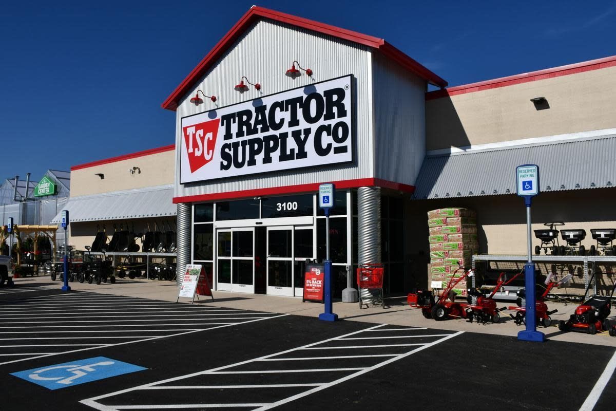 A Tractor Supply Co. store front on a sunny day with handicapped parking spaces in the foreground.
