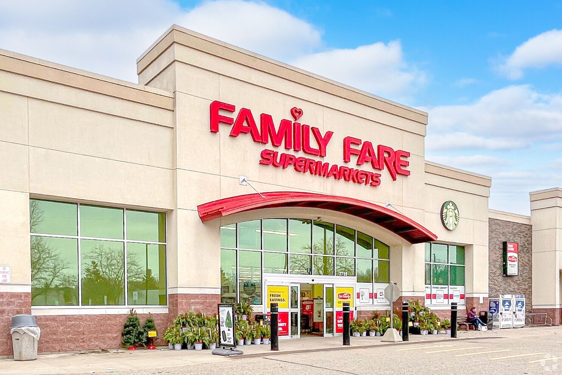 The exterior of a Family Fare Supermarket building on a bright day with a red awning over the entrance.