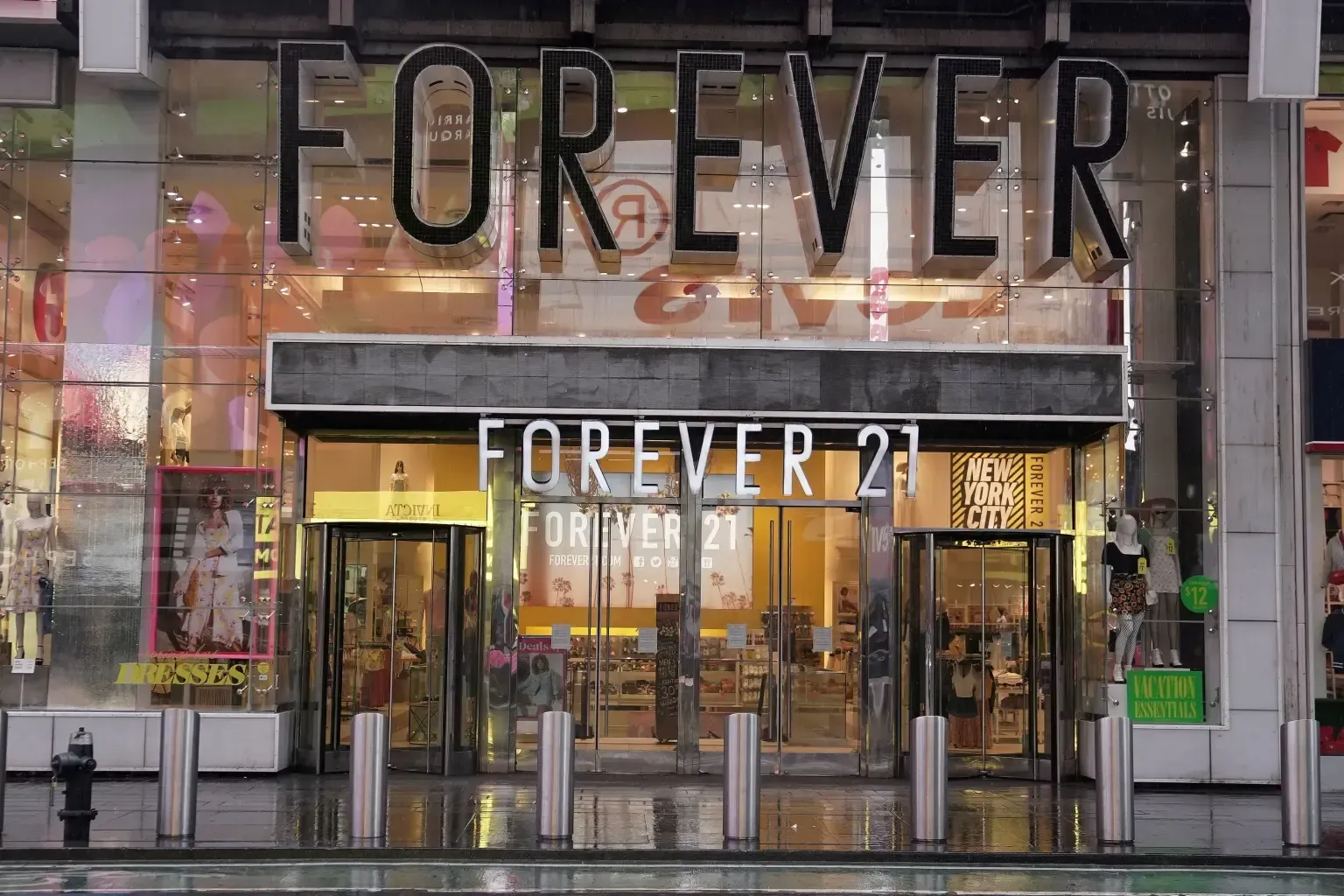 The storefront of a Forever 21 clothing store with prominent signage and glass doors under a metal awning.