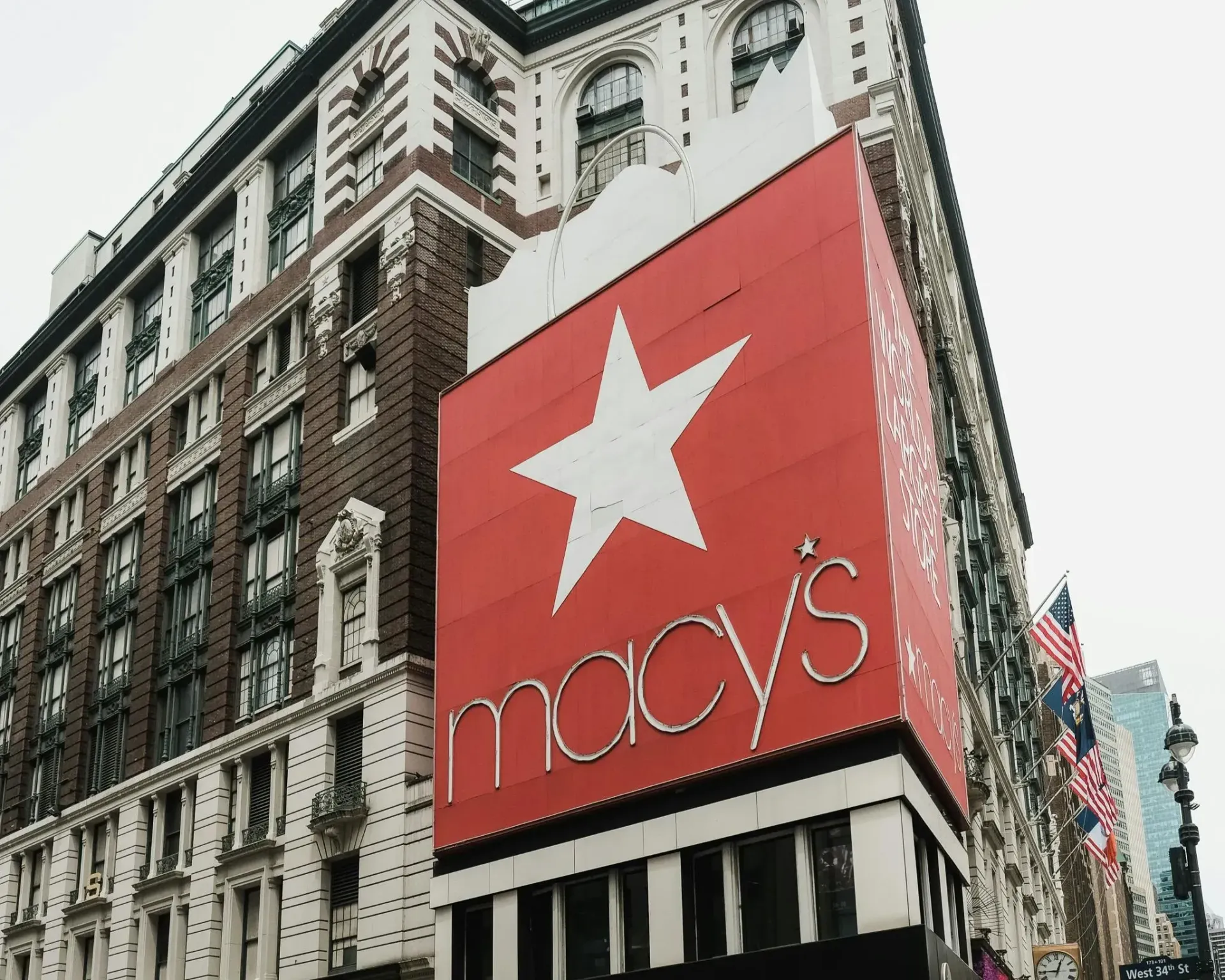A low-angle view of the iconic Macy's department store in New York City, featuring its signature red star signage.