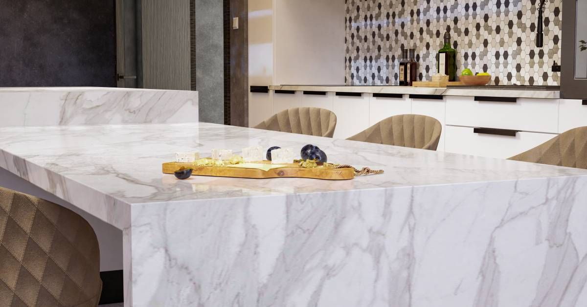 A large natural stone kitchen countertop. The countertop has a small wooden decoration on top of it.