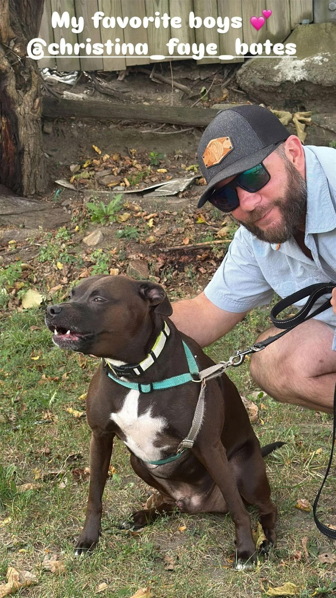 Man crouches beside a brown dog on a leash outdoors, with text “My favorite boys” above them.