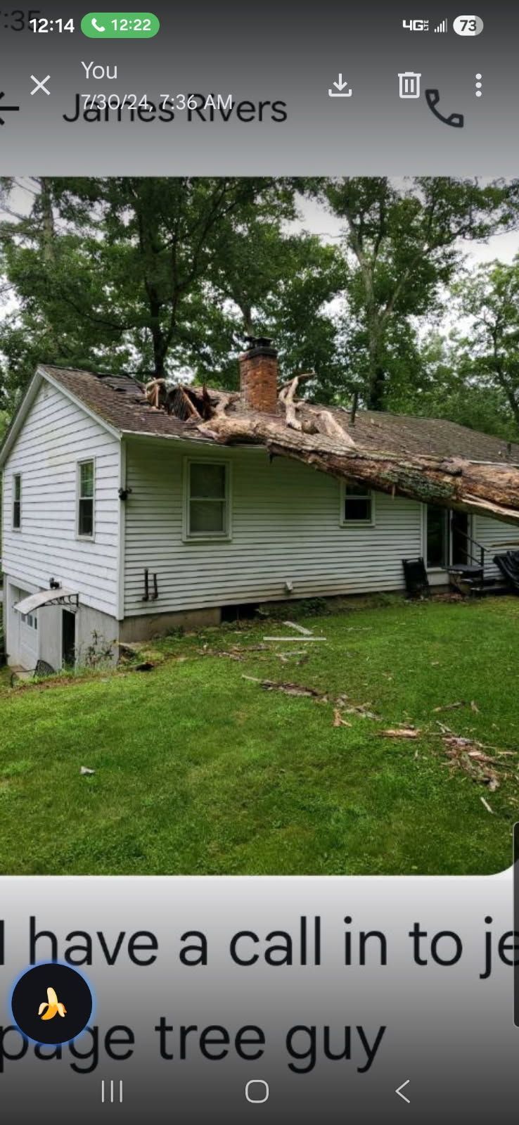 Worker in an orange jacket repairs a damaged roof beside a house.