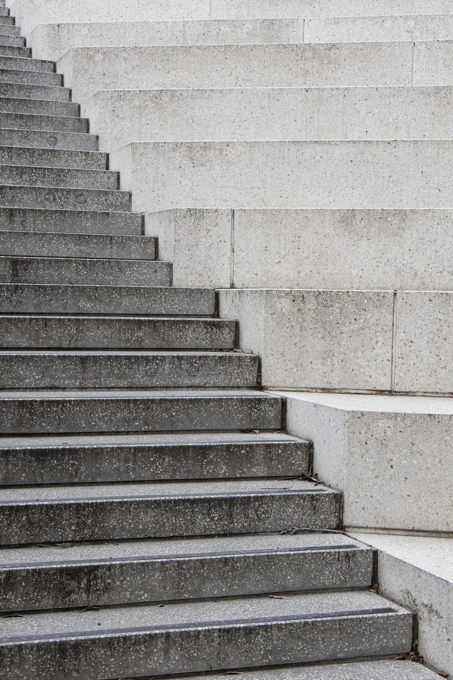 Stone steps leading to a house entrance, with brick accents and a tiled landing.