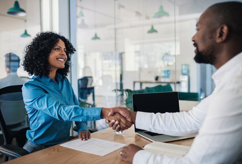 man and woman shaking hands