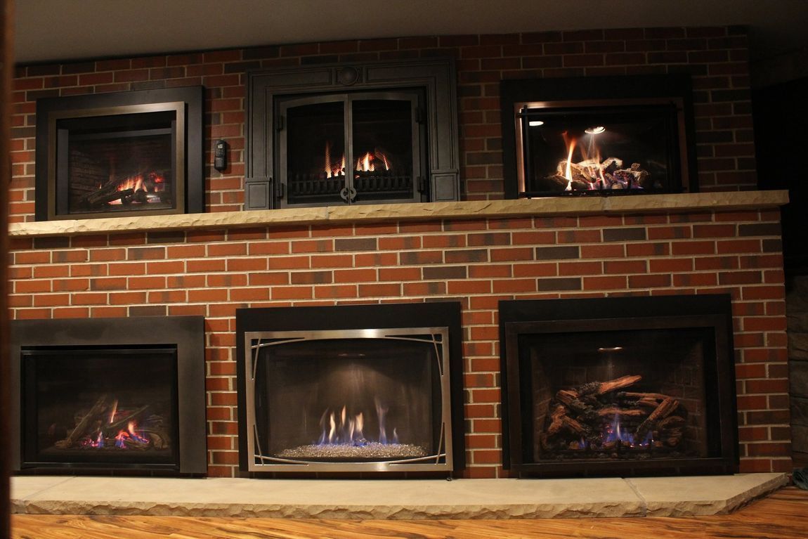 A brick fireplace with a lot of fireplaces in it