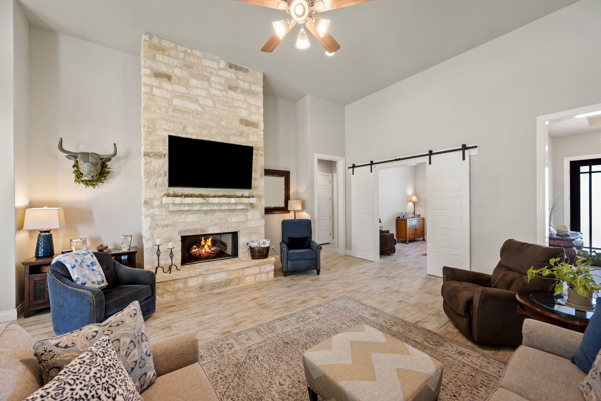 A living room with a fireplace and a flat screen tv.