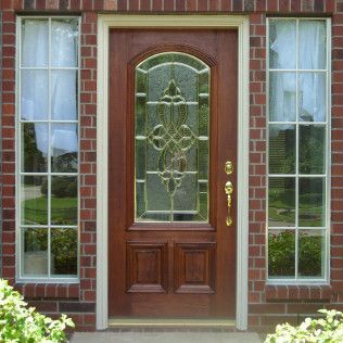 Front Door With Small Square Decorative Windows And Flower Pots