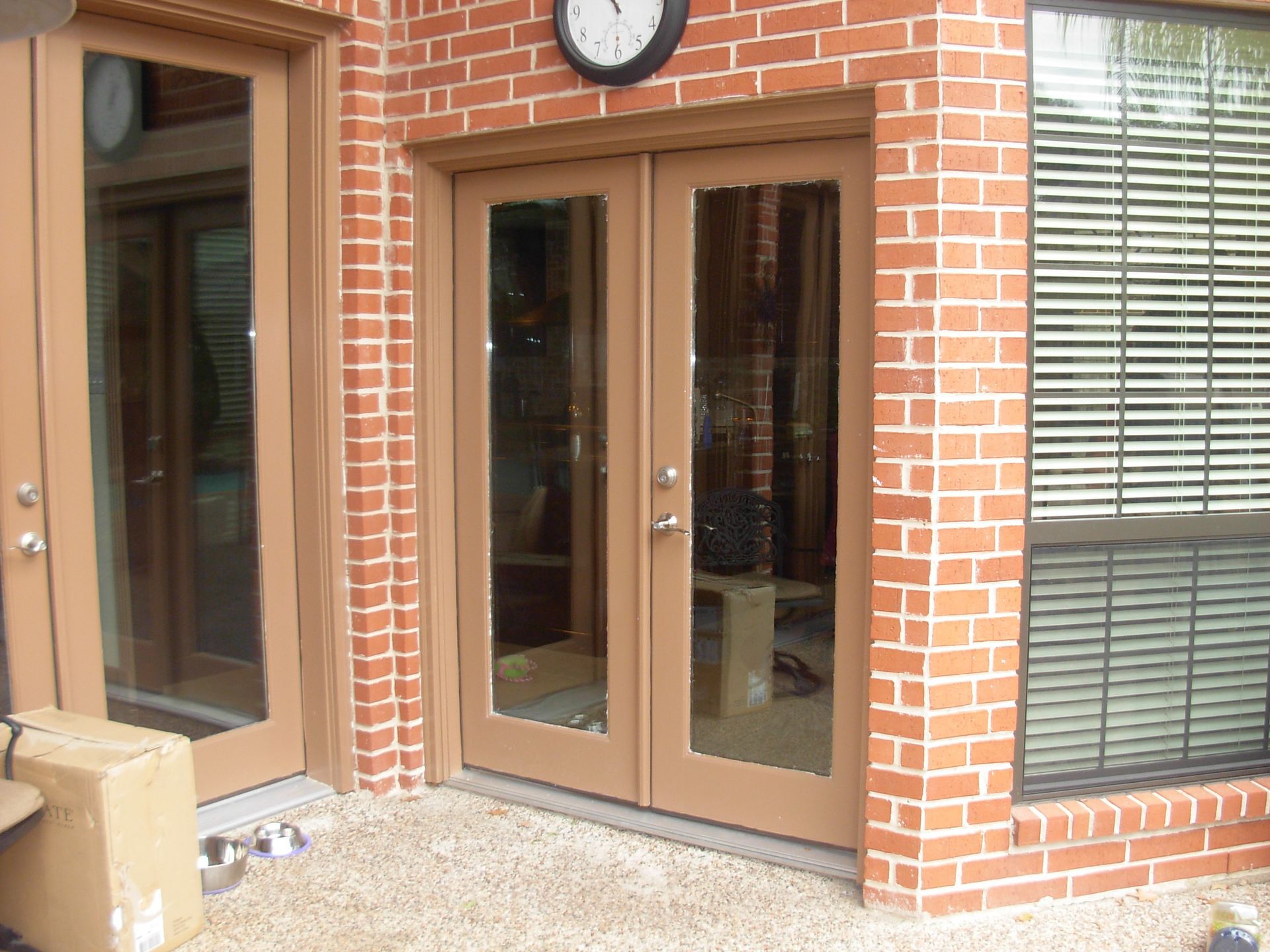 Double Brown Front Door With A Secured Front Entrance