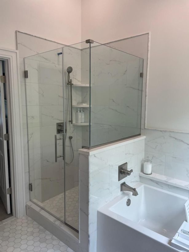 A bathroom with a walk in shower and a bathtub.