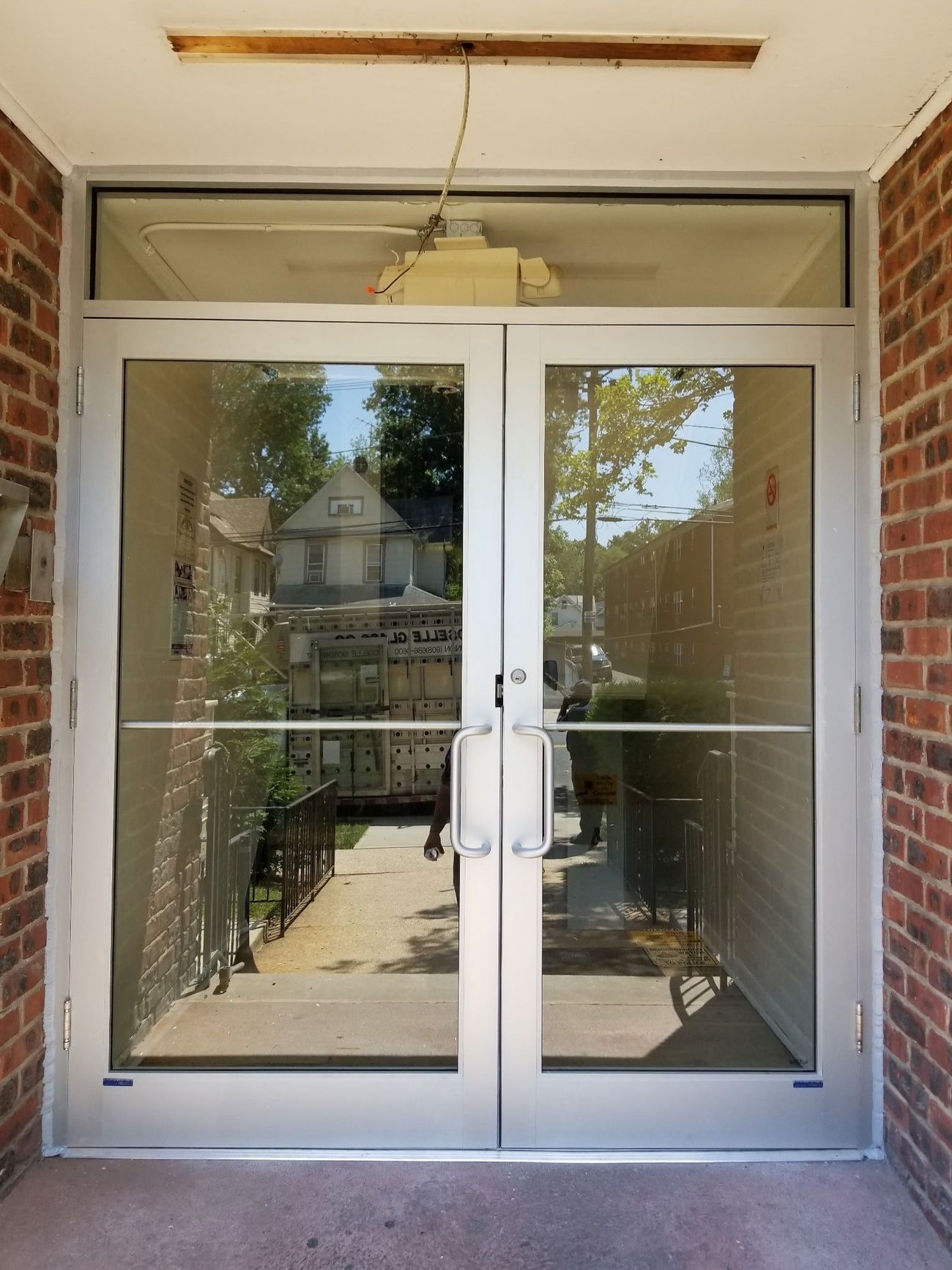 A brick building with a glass door and a ceiling fan.