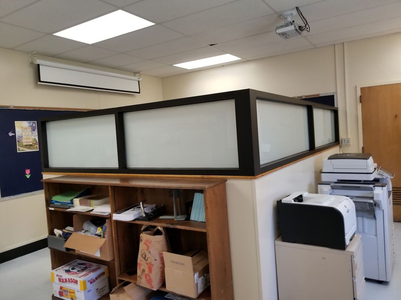 A room with a shelf and a printer in it