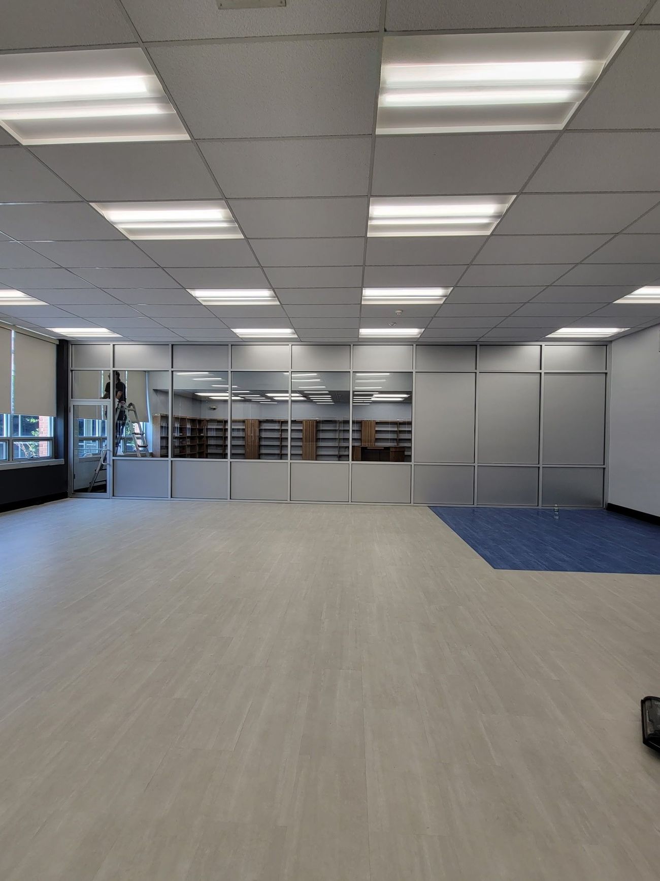 A large empty room with a lot of lights on the ceiling