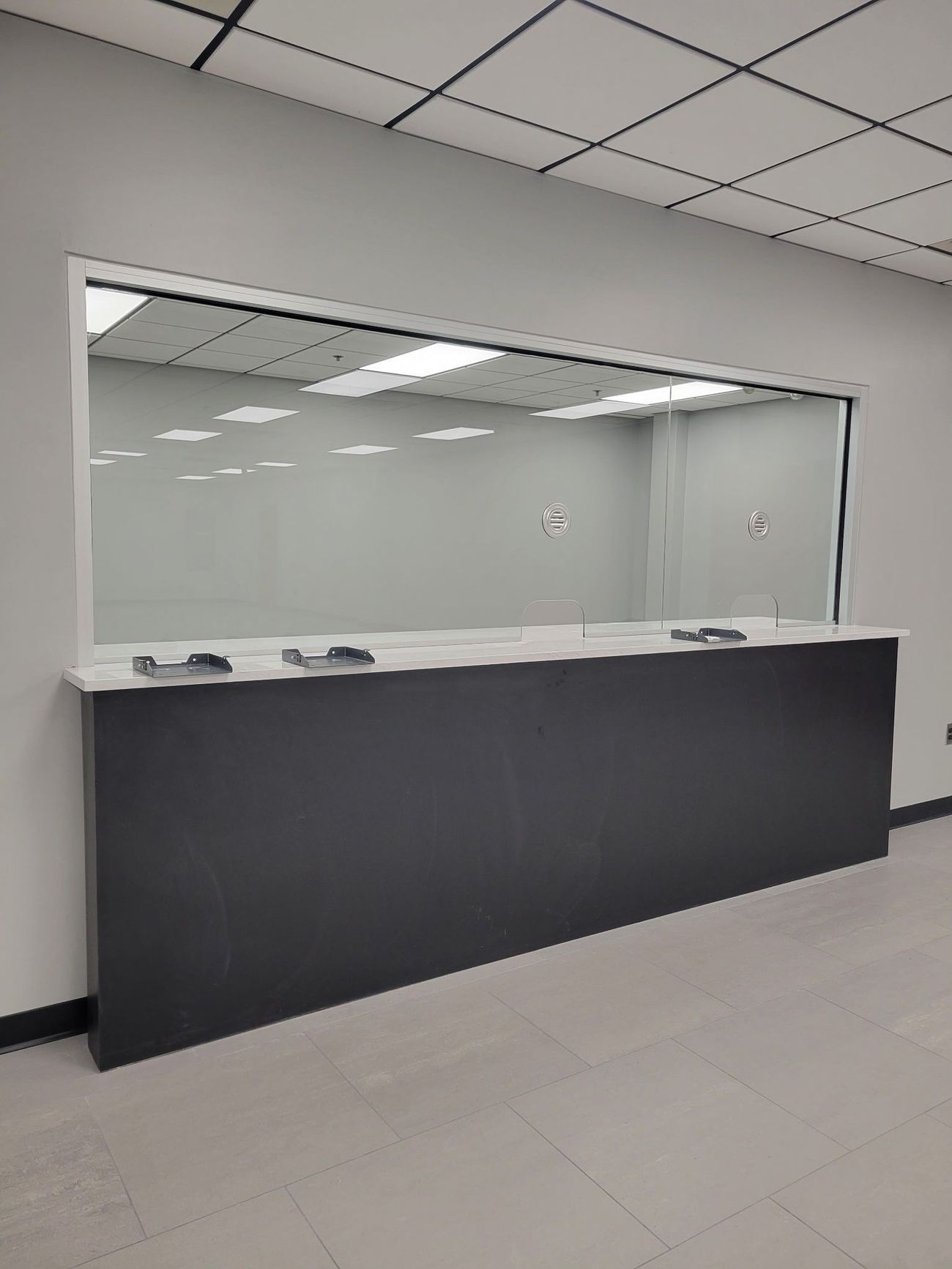 A long counter in a room with a large window.