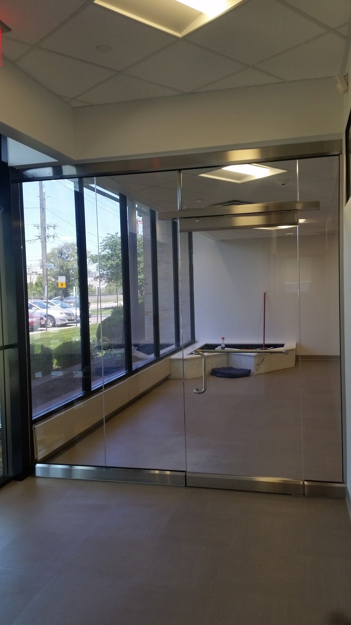 A large empty room with a lot of windows and a pool table.