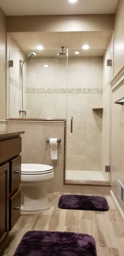 A bathroom with a toilet , sink , and shower.