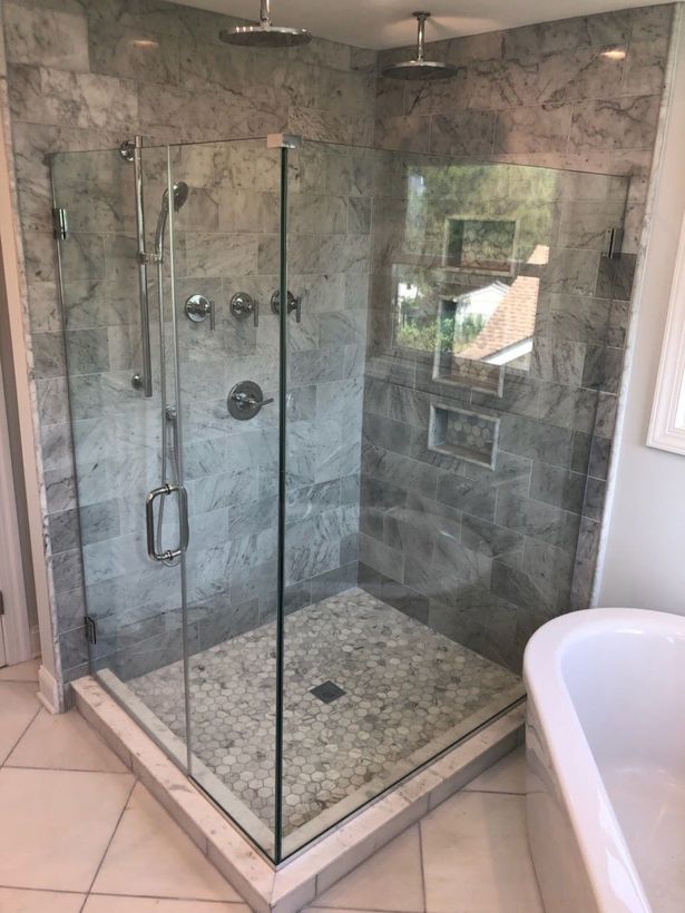 A bathroom with a walk in shower and a bathtub.
