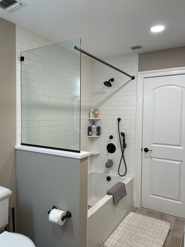 A bathroom with a walk in shower and a bathtub.