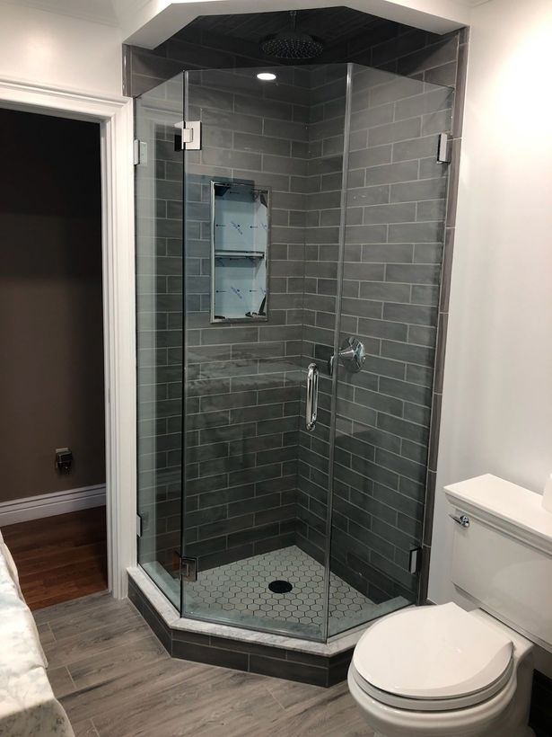 A bathroom with a walk in shower and a toilet.