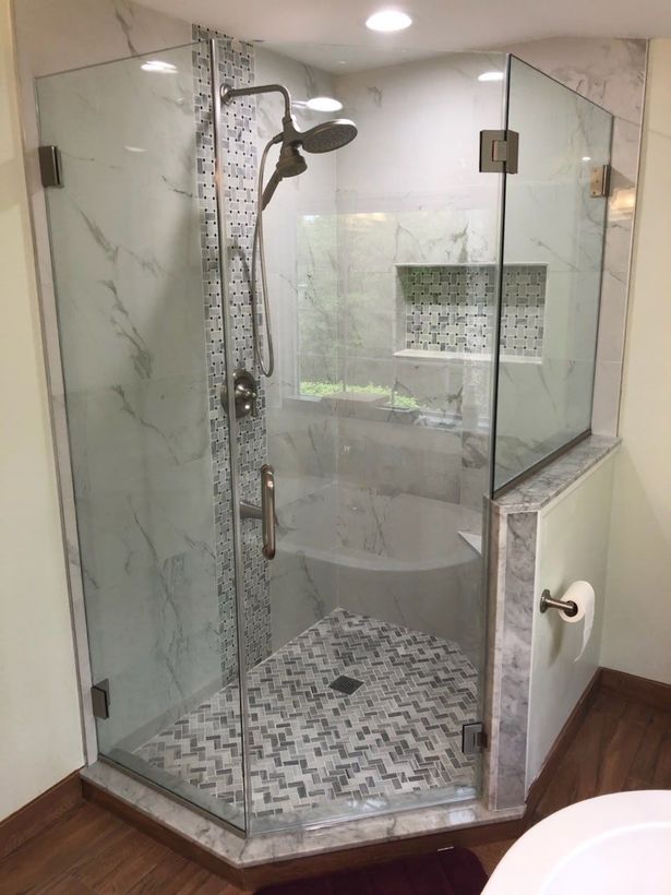A bathroom with a walk in shower and a bathtub.