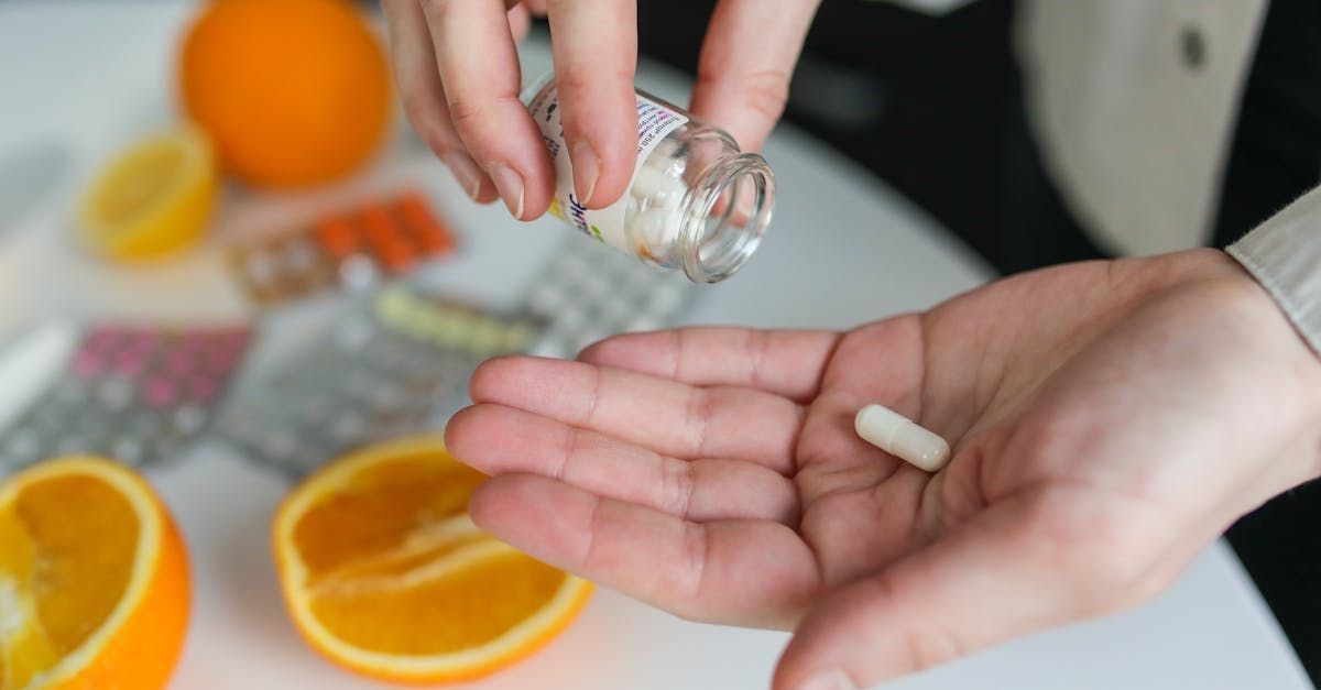 A person is pouring a pill into their hand.