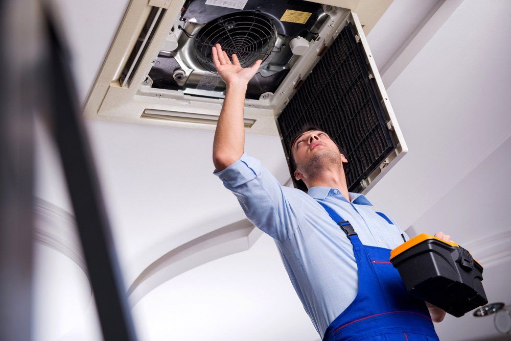 Young Repairman Repairing — Bear Air Conditioning In Bateau Bay, NSW