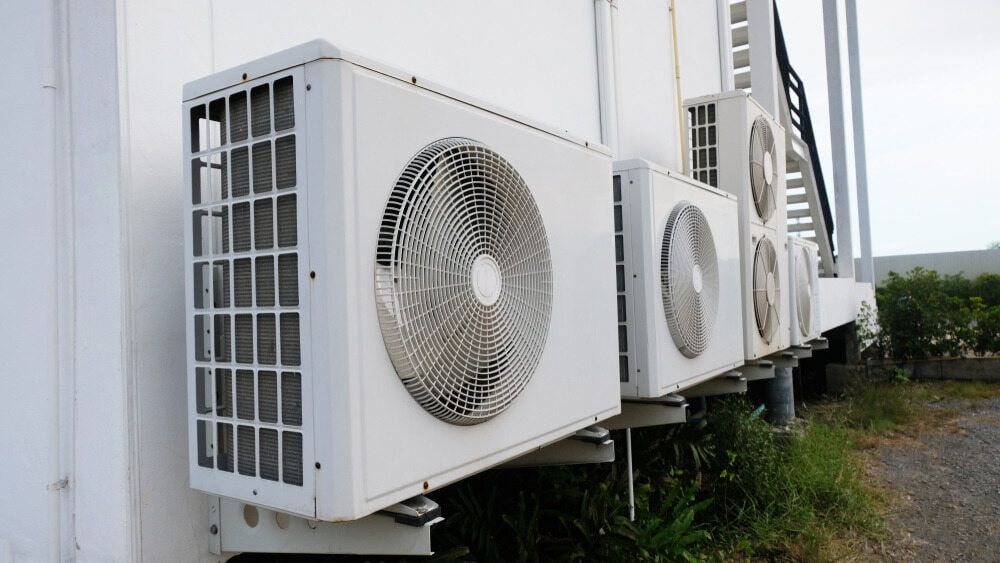 A Row Of Air Conditioners On The Side Of A Building — Bear Air Conditioning In Wyong, NSW
