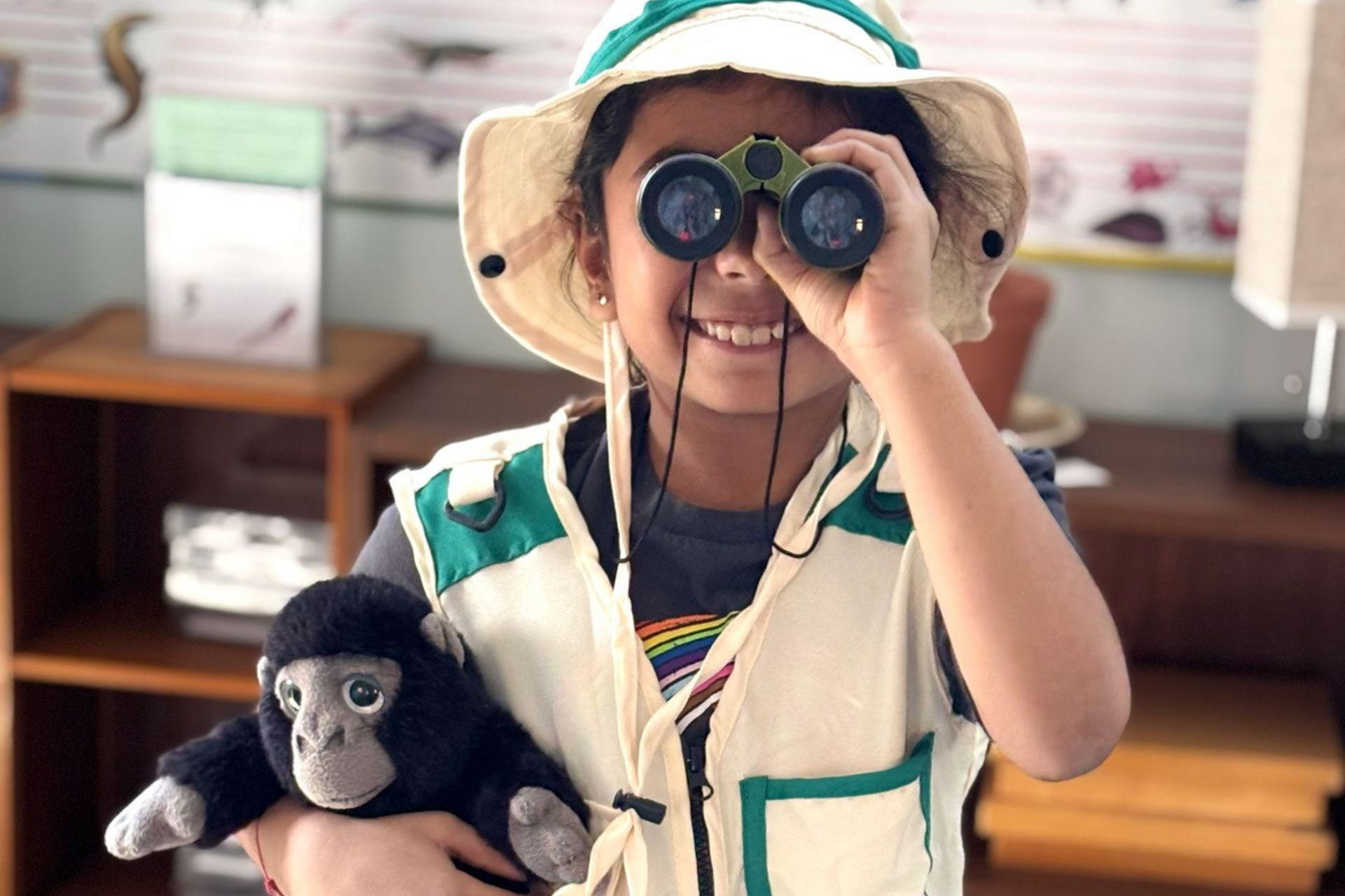 Montessori child dressed as an explorer with binoculars