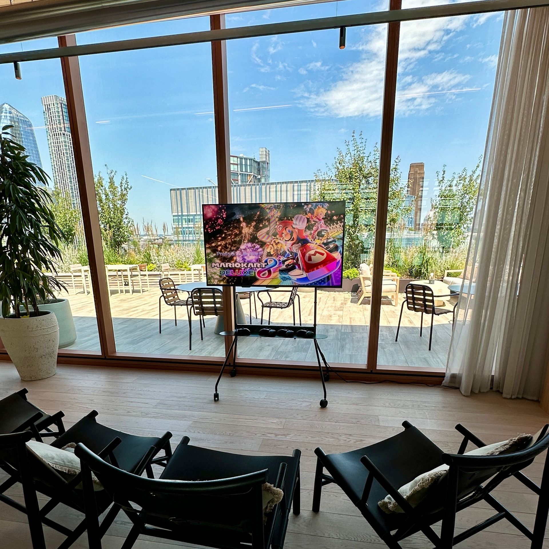 JoyPod 4K, sleek modern console setup with Nintendo Switch and 55