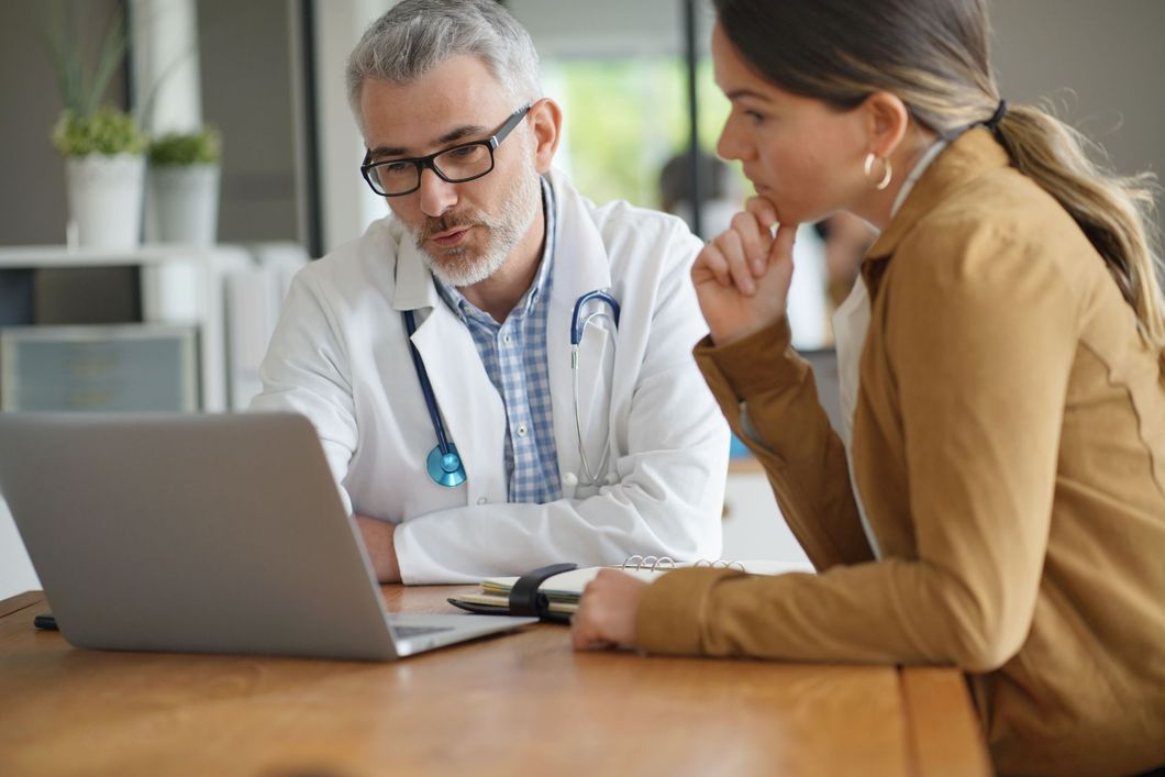 Doctor and patient consulting together