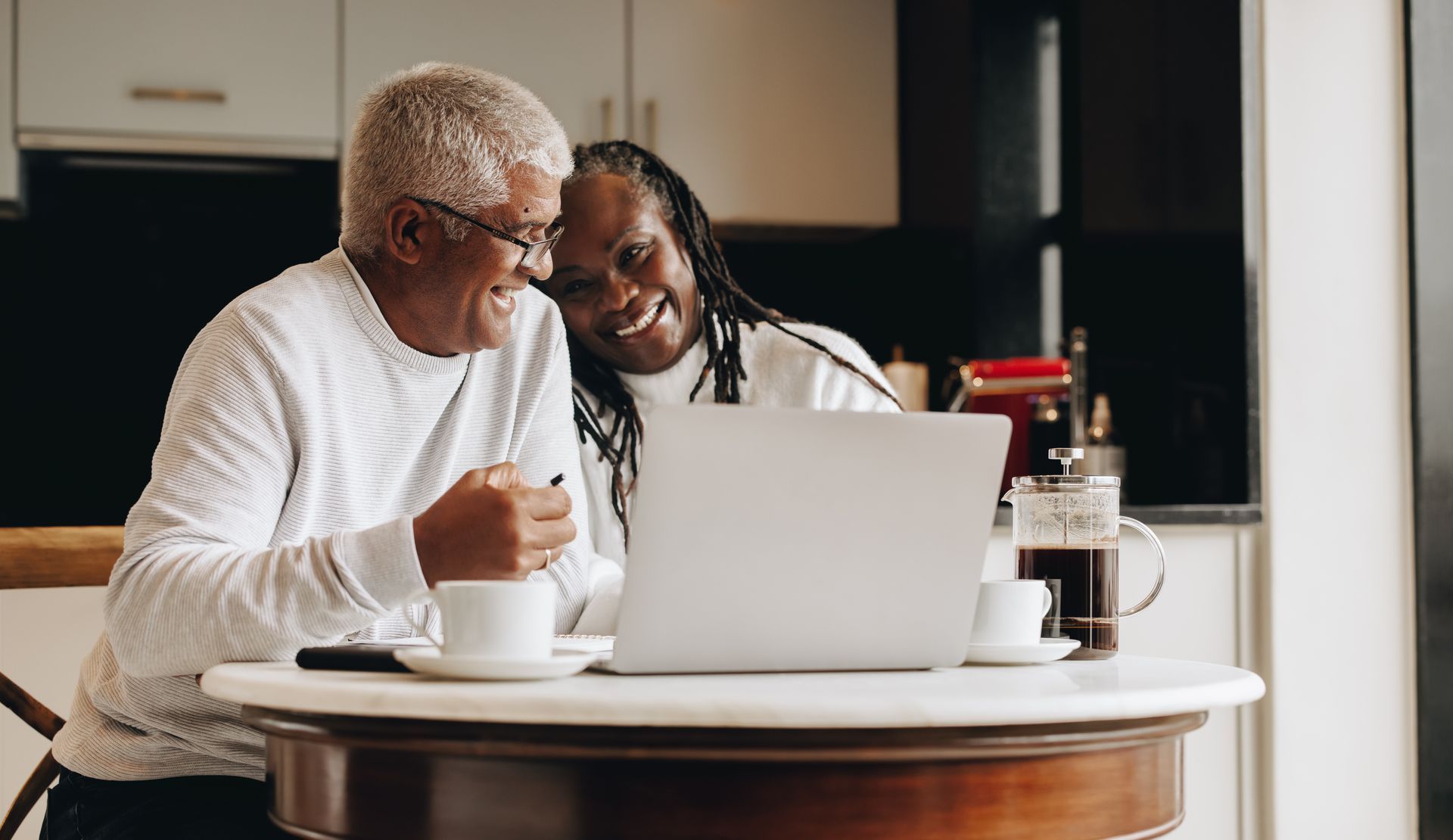 Couple on the couch looking at a laptop together