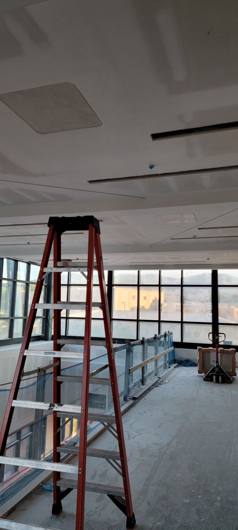 Framed ceiling with exposed plumbing and electrical wiring in a new construction.
