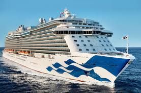 A large cruise ship is floating on top of a body of water.