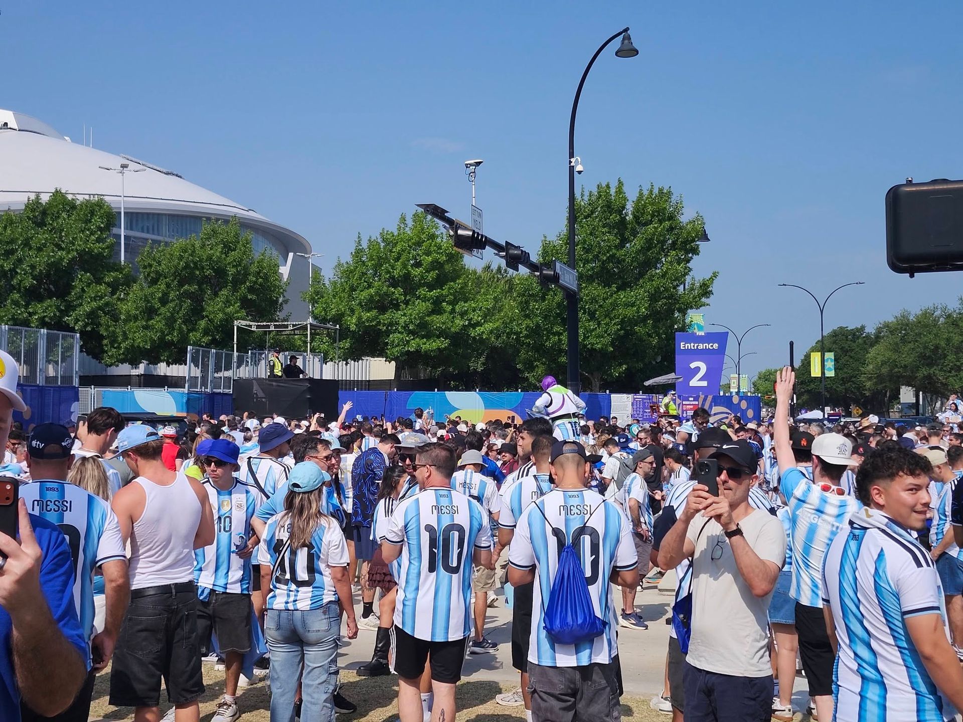 Fans gathered outside the stadium at a FIFA World Cup outreach — every jersey in the crowd is an answer waiting for the question.