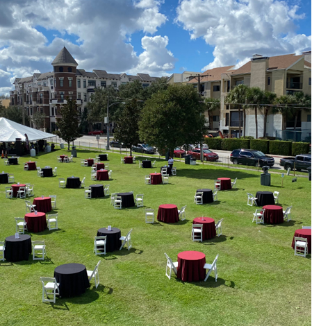 Outdoor event with tables and chairs managed by Aclipse Events