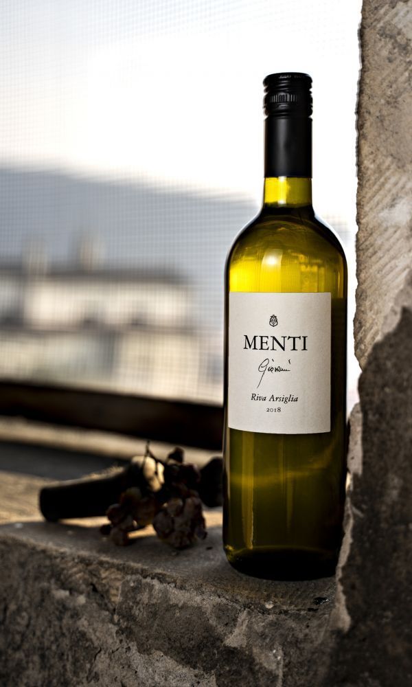 a bottle of Riva Arsiglia wine on a window sill