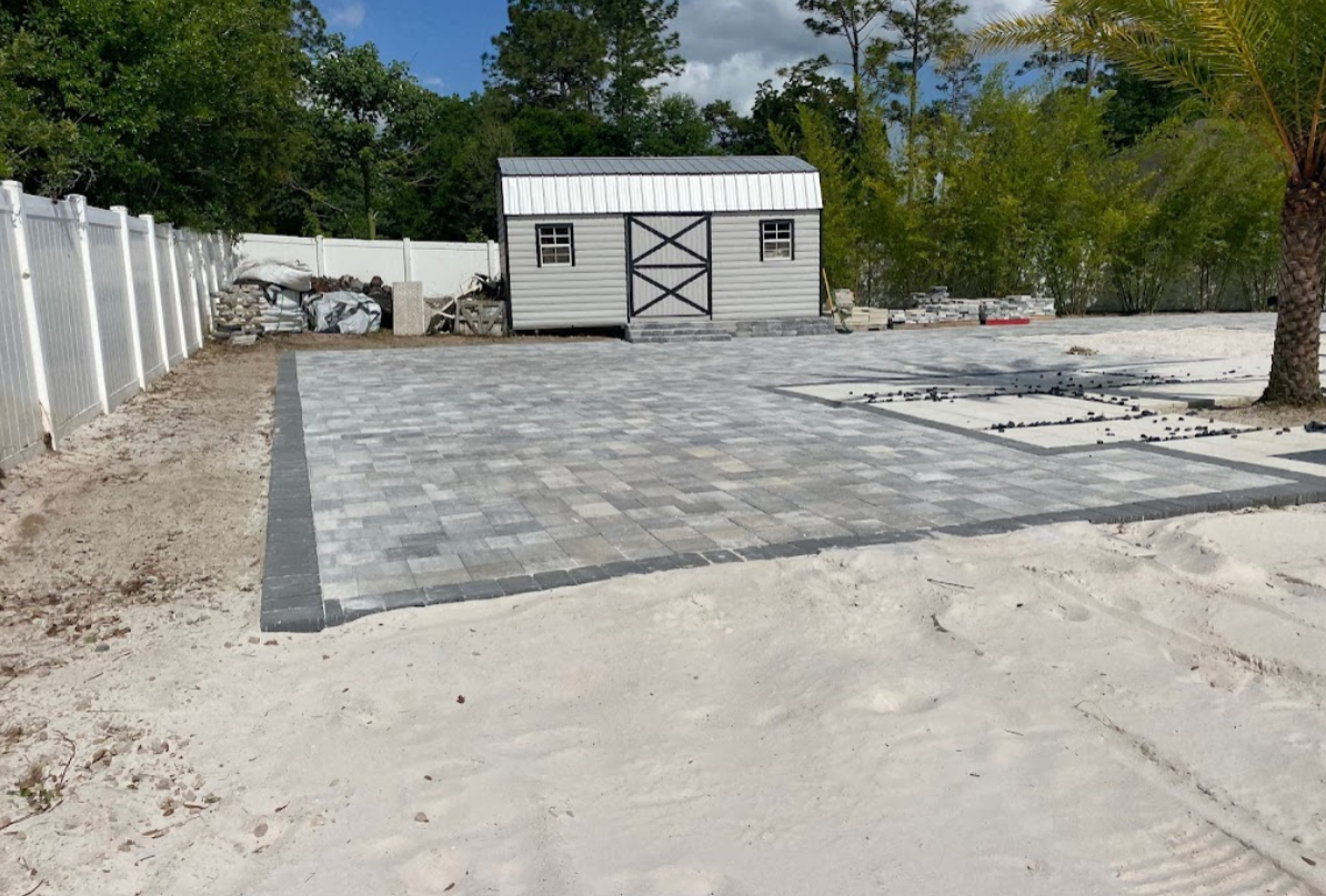 A shed is being built in the backyard of a house.