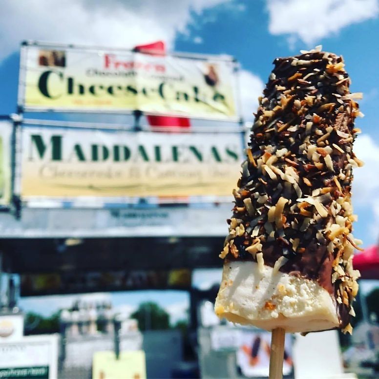 A banana covered in chocolate and coconut on a stick