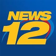 A blue and yellow logo for news 12 on a blue background.