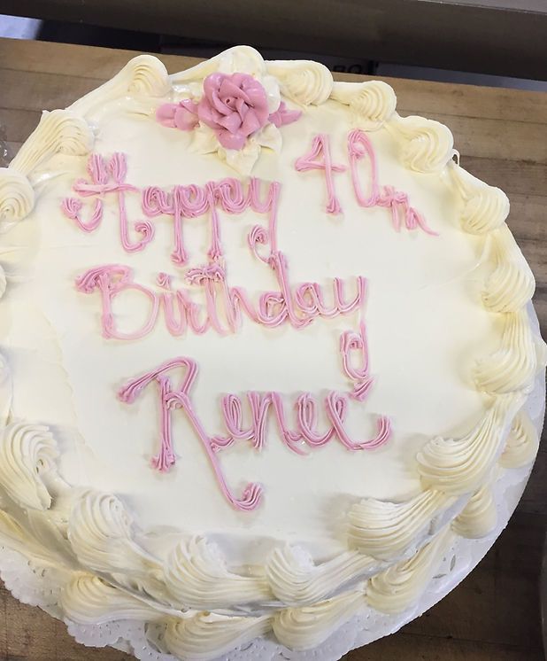 A white cake with pink frosting and the words `` happy 40th birthday renee '' written on it.